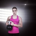 Composite image of muscular woman exercising with kettlebell Royalty Free Stock Photo