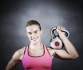 Composite image of muscular woman lifting heavy kettle bell Royalty Free Stock Photo