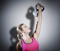 Composite image of muscular woman lifting heavy kettlebell Royalty Free Stock Photo