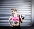 Composite image of muscular woman lifting heavy kettlebell Royalty Free Stock Photo