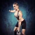 Composite image of muscular woman swinging heavy kettlebell Royalty Free Stock Photo