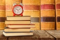 Composite image of old alarm clock and stack of books Royalty Free Stock Photo