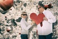 Composite image of older affectionate couple holding red heart shape Royalty Free Stock Photo