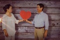 Composite image of older asian couple holding heart Royalty Free Stock Photo