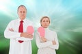 Composite image of older couple standing holding broken pink heart Royalty Free Stock Photo