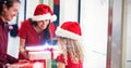 Composite image of parents giving christmas gifts to their daughter