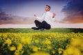 Composite image of peaceful businessman sitting in lotus pose