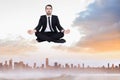 Composite image of peaceful businessman sitting in lotus pose relaxing