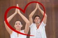 Composite image of peaceful couple in white doing yoga together with hands raised Royalty Free Stock Photo