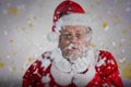 Composite image of playful santa claus blowing fake snow Royalty Free Stock Photo