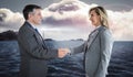 Composite image of pleased businessman shaking the hand of content businesswoman Royalty Free Stock Photo