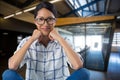 Composite image of portrait of african american woman smiling against empty office in background Royalty Free Stock Photo