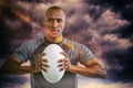 Composite image of portrait of athlete pressing rugby ball