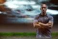 Composite image of portrait of athlete standing with arms crossed Royalty Free Stock Photo