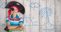 Composite image of portrait of boy pretending to be a pirate Royalty Free Stock Photo