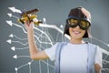 Composite image of portrait of boy wearing flying goggles with toy