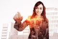 Composite image of portrait of businesswoman touching invisible screen Royalty Free Stock Photo