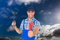 Composite image of portrait of caucasian male worker holding tools against clouds in the blue sky Royalty Free Stock Photo