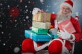 Composite image of portrait of cheerful santa claus holding christmas presents on chair Royalty Free Stock Photo