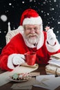 Composite image of portrait of cheerful santa claus holding coffee mug Royalty Free Stock Photo