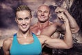 Composite image of portrait of confident cheerful man and woman flexing muscles