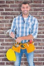 Composite image of portrait of confident repairman holding hammer Royalty Free Stock Photo