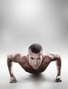 Composite image of portrait of confident shirtless man doing push ups Royalty Free Stock Photo