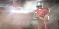 Composite image of portrait of confident sports player in red jersey holding ball Royalty Free Stock Photo