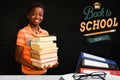 Composite image of portrait of cute boy carrying books in library Royalty Free Stock Photo