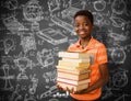 Composite image of portrait of cute boy carrying books in library Royalty Free Stock Photo