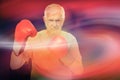 Composite image of portrait of a determined senior boxer