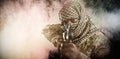 Composite image of portrait of face covered soldier aiming with rifle Royalty Free Stock Photo
