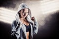 Composite image of portrait of female boxer in hood with fighting stance Royalty Free Stock Photo