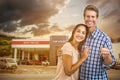 Composite image of portrait of happy couple with keys Royalty Free Stock Photo