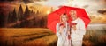 Composite image of portrait of happy couple under red umbrella Royalty Free Stock Photo