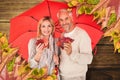 Composite image of portrait of happy couple under red umbrella Royalty Free Stock Photo