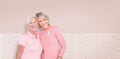 Composite image of portrait of happy daughter with mother supporting breast cancer awareness Royalty Free Stock Photo