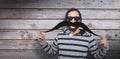 Composite image of portrait of happy hipster wearing sunglasses Royalty Free Stock Photo