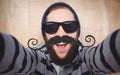 Composite image of portrait of happy hipster wearing sunglasses Royalty Free Stock Photo