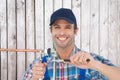 Composite image of portrait of happy plumber fixing pipe Royalty Free Stock Photo