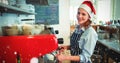 Composite image of portrait of happy waitress wearing santa hat Royalty Free Stock Photo