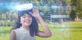 Composite image of portrait of happy young woman with virtual reality simulator