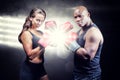 Composite image of portrait of male and female athletes with fighting stance Royalty Free Stock Photo