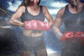 Composite image of portrait of male and female boxers with gloves Royalty Free Stock Photo