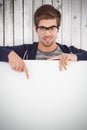 Composite image of portrait of man wearing eyeglasses pointing on billboard Royalty Free Stock Photo