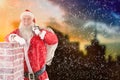 Composite image of portrait of santa claus carrying bag full of gifts Royalty Free Stock Photo