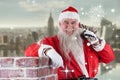 Composite image of portrait of santa claus carrying bag full of gifts Royalty Free Stock Photo