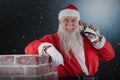 Composite image of portrait of santa claus carrying bag full of gifts Royalty Free Stock Photo