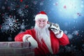 Composite image of portrait of santa claus carrying bag full of gifts Royalty Free Stock Photo