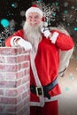 Composite image of portrait of santa claus carrying bag full of gifts Royalty Free Stock Photo